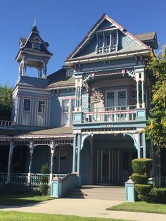 a blue and pink house with two towers