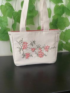 This bag combines natural beauty with handcrafted elegance! Adorned with meticulously hand-embroidered floral patterns on durable Natural Linen, this bag is unique and special in every detail. Measuring 28 cm x 23 cm x 11 cm, this bag offers both stylish and practical options for daily use. ✨ Features: Spacious Interior: The bag features three different compartments; a zippered pocket, a regular pocket, and a bottle pocket to easily organize your belongings. Easy Use: The magnetic snap closures allow for easy opening and closing. Comfortable Strap: The 6 cm strap ensures comfortable carrying. Natural Linen: Made from durable Natural Linen, adorned with handcrafted floral embroidery. This bag is not just an accessory but also a companion that reflects your style and appreciation for craftsm Floral Embroidered Tote Shoulder Bag For Daily Use, Everyday Floral Embroidery Tote Shoulder Bag, Everyday Tote Shoulder Bag With Floral Embroidery, Everyday Floral Embroidered Tote Shoulder Bag, Everyday Floral Embroidery Shoulder Bag, Floral Embroidered Satchel Bag For Everyday, Floral Embroidered Satchel For Everyday Use, Elegant Satchel Shoulder Bag With Floral Embroidery, Embroidered Cream Shoulder Bag