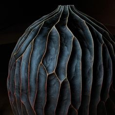 a large black vase sitting on top of a table