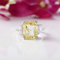 a yellow diamond ring sitting on top of a table