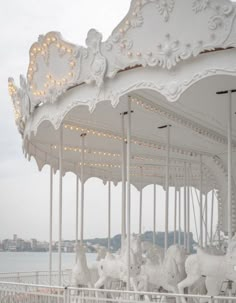 a white merry go round with lights on it