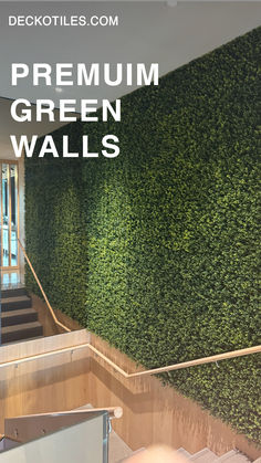 a green wall with stairs leading up to it and the words, premium green walls