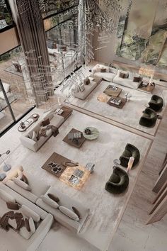 an aerial view of a living room with couches, tables and chairs in it