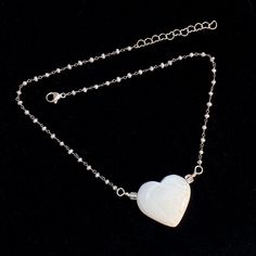 All genuine gemstone with this more rare heart called a Scolecite. With natural very light blue topaz and wrapped fresh water pearls. 16.5" long 2" silver chain, 18.5" total length A definite piece to cherish forever. One of my one of a kinds. Very special. Makes a great gift. White Jewelry With Heart Beads For Healing, White Spiritual Jewelry With Heart Charm, White Heart Pendant Spiritual Jewelry, White Heart Necklace With Pearl Pendant, White Necklace With Silver Chain As Gift, White Necklace With Silver Chain For Gift, Spiritual White Heart Pendant Jewelry, Sterling Silver White Heart Beads Jewelry, White Heart-shaped Pearl Chain Necklace