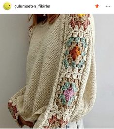 a woman is wearing a sweater with crocheted flowers on the sleeves and back