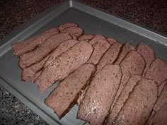 sliced meat on a baking sheet ready to be cooked in the oven for dinner time