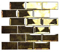 a close up view of a mosaic tile wall with gold and black designs on it