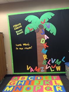 a classroom door decorated with letters and a palm tree