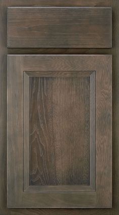 a close up view of a wooden cabinet door with woodgrain and metal trim