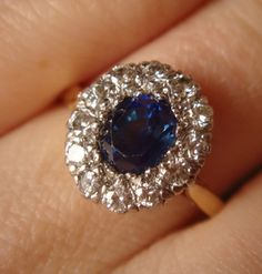 Sapphire and diamond cluster ing. #crispinjewellery Brilliant Cut Sapphire Cluster Jewelry, Luxury Sapphire Cluster Jewelry, Victorian Cluster Ring Hallmarked, Luxury Vintage Cluster Sapphire Ring, Luxury Antique Hallmarked Cluster Ring