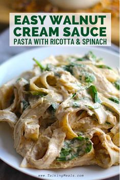 pasta with ricotta and spinach sauce on a white plate