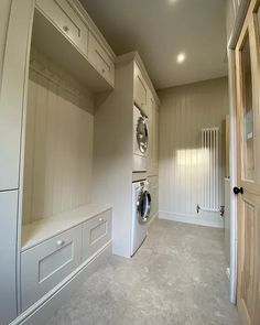 an empty laundry room with washers and dryer in it's closets