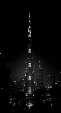 a black and white photo of the burj tower in new york city at night