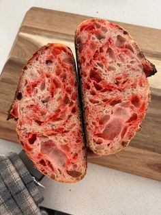 two pieces of bread with meat on them sitting on a cutting board next to a knife