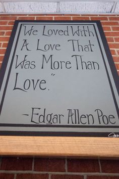 a sign on the side of a brick building that reads we loved with a love that was more than love