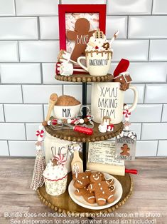 a three tiered tray with cookies and mugs on it that says xmas baking team