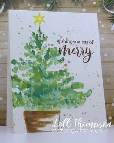 a handmade christmas card with a watercolor painting of a tree in a pot