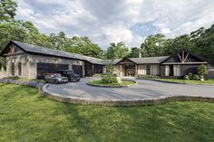 two motorcycles are parked in front of a large house with driveway and landscaping around it