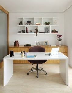 a white desk with a laptop on it