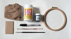 the supplies needed to make this diy wooden hoop are laid out on a white surface