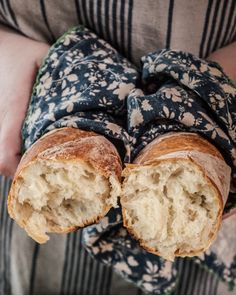 a person is holding some bread in their hands