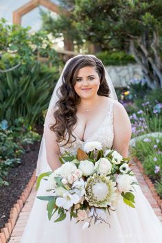 a woman in a wedding dress holding a bouquet