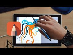 a person is drawing on an ipad