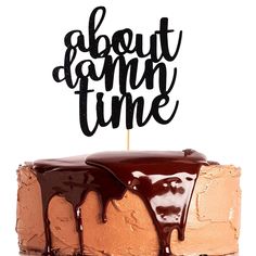 a chocolate cake with the words about damn time on top