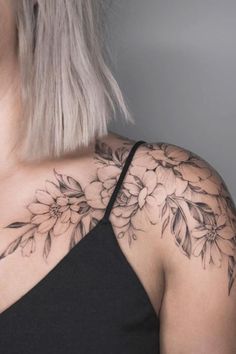 a woman's shoulder with flowers on it