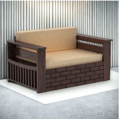 a wooden couch sitting on top of a white floor next to a metal building wall