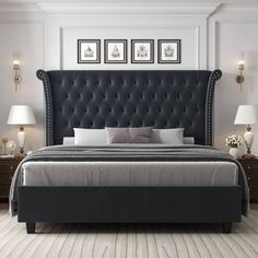 a bed with a tufted headboard and foot board in a white room next to two lamps