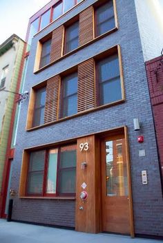 an apartment building with wooden shutters on the front