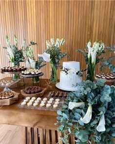 a table topped with lots of desserts and flowers