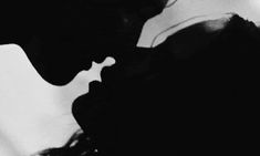 the silhouette of a man and woman are shown in this black and white photo together