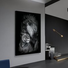 a black and white photo of a lion on the wall next to a blue chair