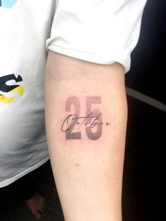 a person with a tattoo on their arm and the number twenty five in it's center