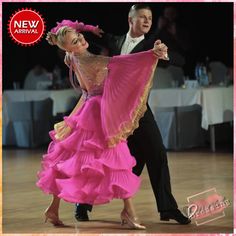 a man and woman in ballroom clothes dancing