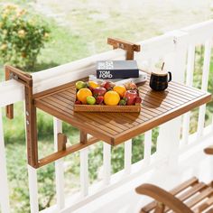 a basket of fruit sitting on top of a wooden table next to a coffee cup