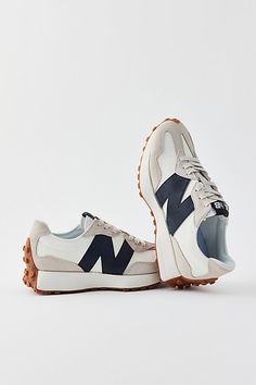 The 327 boldly reshapes ‘70s design elements with a thoroughly contemporary outlook – a flared midsole, rubber heel wrap, trail-inspired lug outsole and oversized ‘N’ branding provide a complete reimagination of New Balance’s running heritage – plus an exaggerated fang design upper and a nylon tongue for a retro feel. Content + Care Synthetic, rubber Spot clean Imported Size + Fit True to size | New Balance 327 Women's Sneaker in Moonbeam/Black, Women's at Urban Outfitters New Balance 327 Women, Trendy Tennis Shoes, Trendy Womens Sneakers, Spring Shoes Women, Sneakers Trendy, Converse Run Star, Fall Booties, New Balance 327, Retro Styles