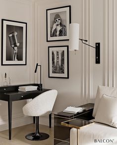 a living room with white walls and pictures on the wall, including a black desk