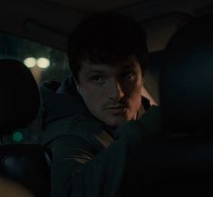 a man sitting in the back seat of a car