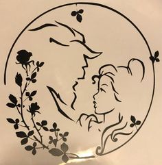 a stencil depicting a couple kissing in front of a circular frame with flowers and butterflies