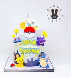 a pokemon themed birthday cake on a white background