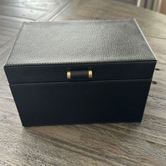 a black box sitting on top of a wooden table