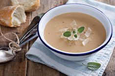 a bowl of soup with bread on the side