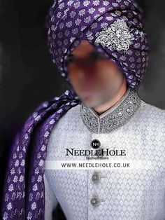 a man wearing a purple turban and white shirt with an intricate pattern on it