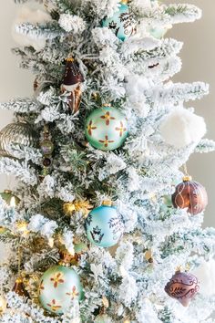 a white christmas tree with ornaments on it