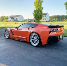 an orange sports car parked on the street