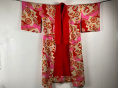 "Vintage 1920s or 30s ? silk kimono robe. Pink and red playful party printed fabric. Can be worn as a jacket or a robe. High quality construction. Probably one size fits all, measures like a large. Actual measurements:   46\" around the chest  46\" around the waist  51\" wide when hung  52\" long when hung, plus 4\" collar In very good condition except for worn back bottom edge, see last two pictures." Vintage Pink Robe For Spring, Long Pink Silk Robe, Bohemian Pink Kimono For Wedding, Pink Bohemian Kimono For Wedding, Pink Bohemian Wedding Kimono, Vintage Long Red Kimono, Vintage Red Long Kimono, Red Vintage Kimono For Spring, Long-sleeved Pink Vintage Robe