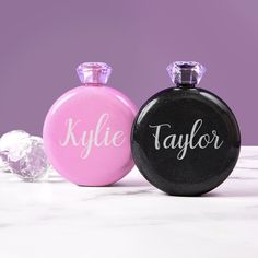 two black and pink flasks with the word taylor on them